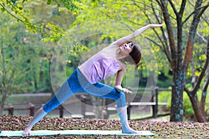 Portrait of Japanese woman doing yoga exercise outdoor