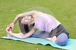 Portrait of Japanese woman doing yoga exercise outdoor