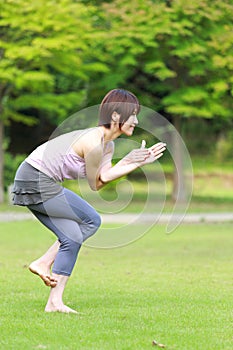 Portrait of Japanewe woman doing yoga eagle pose