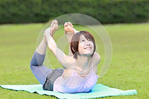 Portrait of Japanewe woman doing yoga frog pose