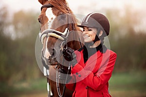 Portrait Jockey woman rider with brown horse, concept advertising equestrian club school