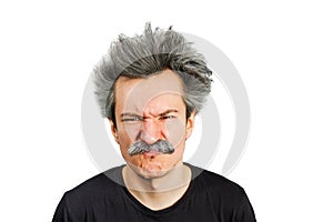 Portrait of jocular aging man wrinkles his nose from sour on his face in Einstein manner. Isolated on background