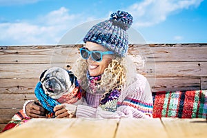 Portrait of joy woman hugging her old dog in outdoor leisure activity in winter day holiday. One female people in friendship with