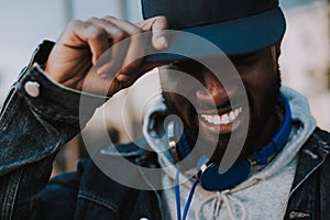 Portrait of a joyful afro american man wearing his cap