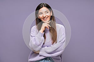 Portrait of joyful beautiful and vibrant woman in love planning in mind. Purple clothes and background