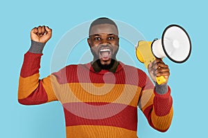 Portrait Of Joyful Black Man With Megaphone In Hands Making Announcement