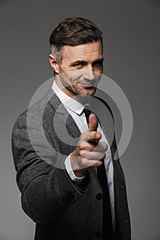 Portrait of joyful business man wearing business suit posing on
