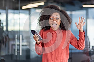 Portrait joyful business woman winner, employee entrepreneur smiling and looking at camera, celebrating successful