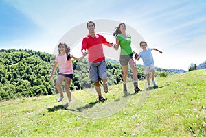 Portrait of joyful family running in nature