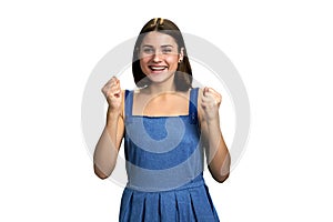 Portrait of joyful girl with clenched fists.