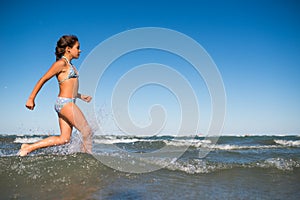 Portrait of a joyful little girl swimming in sea