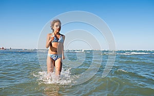 Portrait of a joyful little girl swimming in sea