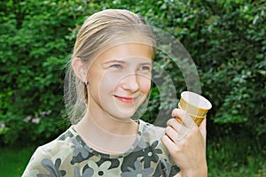 Portrait of a joyful teenage girl with ice cream in her hand