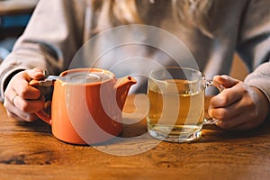 Portrait of a joyful teengirl enjoying a cup of tea at cafe