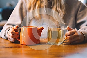 Portrait of a joyful teengirl enjoying a cup of tea at cafe