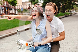 Portrait of a joyful young couple riding
