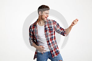 Portrait of a joyful young man playing on a guitar