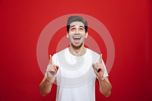 Portrait of a joyful young man in white t-shirt