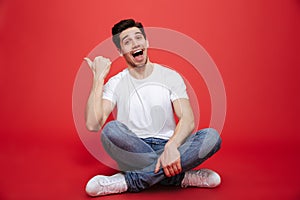 Portrait of a joyful young man in white t-shirt