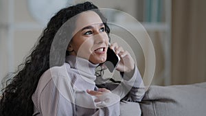 Portrait joyful young woman resting at home talking on telephone excited hispanic girl enjoy nice friendly chat share