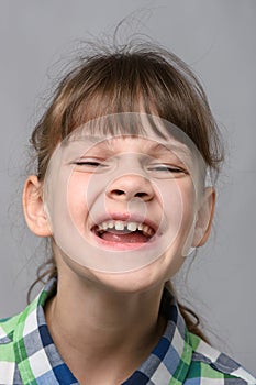 Portrait of a joyfully smiling ten-year-old girl of European appearance, close-up