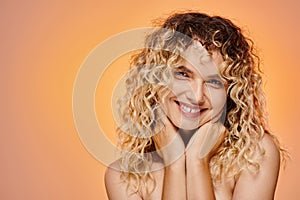 portrait of joyous curly woman with