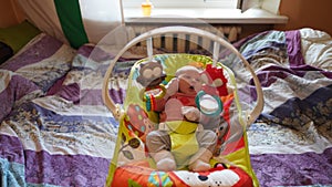 Portrait of just born baby in pink blouse lying in a cradle