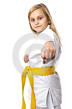 Portrait of a karate girl in kimono with yellow belt ready to fight