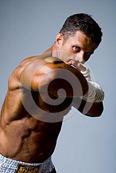 Portrait of a kick boxer in fighting stance.