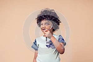 A portrait of kid boy holding magnifier glass. Children and education concept