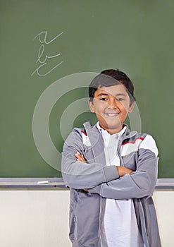 Portrait, kid or boy student by chalkboard for knowledge, education or development for future growth. Scholarship, smile