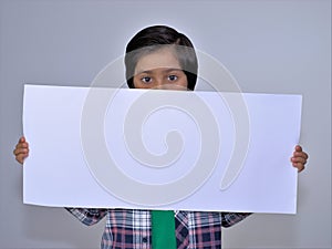 Portrait of kid holding empty placard