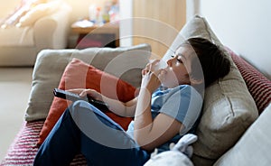 Portrait Kid holding remote control and biting finger nails while watching cartoon on TV, Emotional Young boy deep in thought,