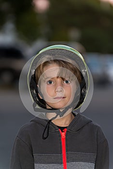 Portrait of a kid wearing a bicycle helmet incorrectly