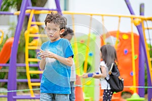 Portrait of kids boy having fun at children`s climbing toy with