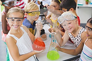 Portrait of kids holding laboratory flask in laboratory