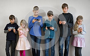 Portrait of kids playing with their phones