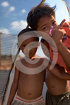 Portrait of Kids playing at the trampoline at the music scene area after Cambodia beer event party,