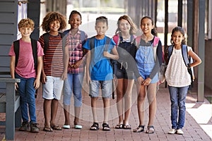 Portrait of kids standing in elementary school hallway