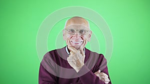 Portrait of kindly funny man in glasses laughing and holding chin with hand