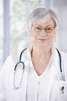 Portrait of kindly smiling female senior doctor