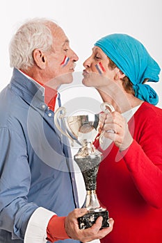 Kissing senior couple and french supporter