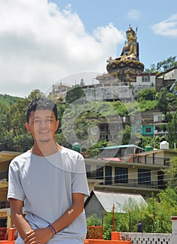 Portrait of a Ladakhi young guy standing against the beautiful hilly area of Tso-Pema and Padmasambhava Guru Rinpoche