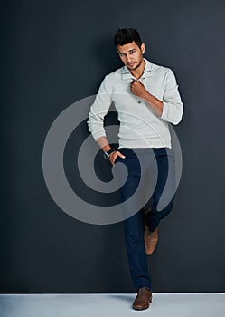 Portrait of a ladies man. Studio shot of a handsome young man against a dark background.