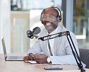 Portrait, laptop and news with a black man radio presenter writing in a notebook during a live broadcast. Computer