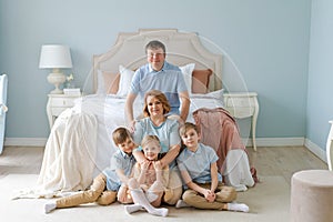 Portrait large family five people father mother two sons and daughter lying