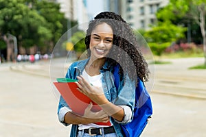 Portrait of latin american young adult student with retainer