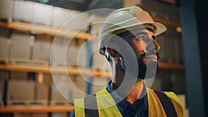 Portrait of Latin Male Worker Wearing Hard Hat Standing Outside of Warehouse Smiling. Professional