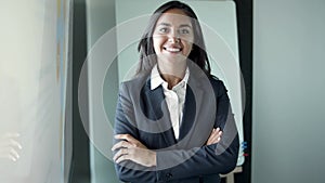 Portrait of Latin pretty young businesswoman standing in office