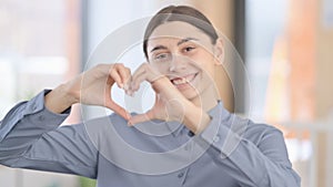 Portrait of Latin Woman showing Heart Shape by Hands